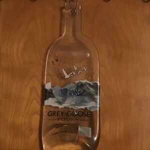 A squished glass grey goose hanging bottle